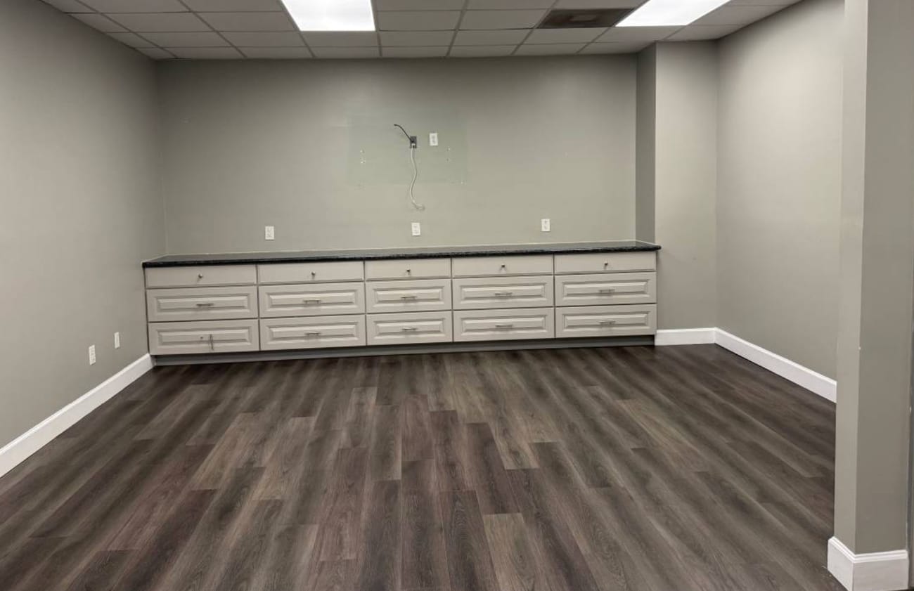Shared office suite — League City Open shared office suite with wood-look flooring and built-in cabinetry